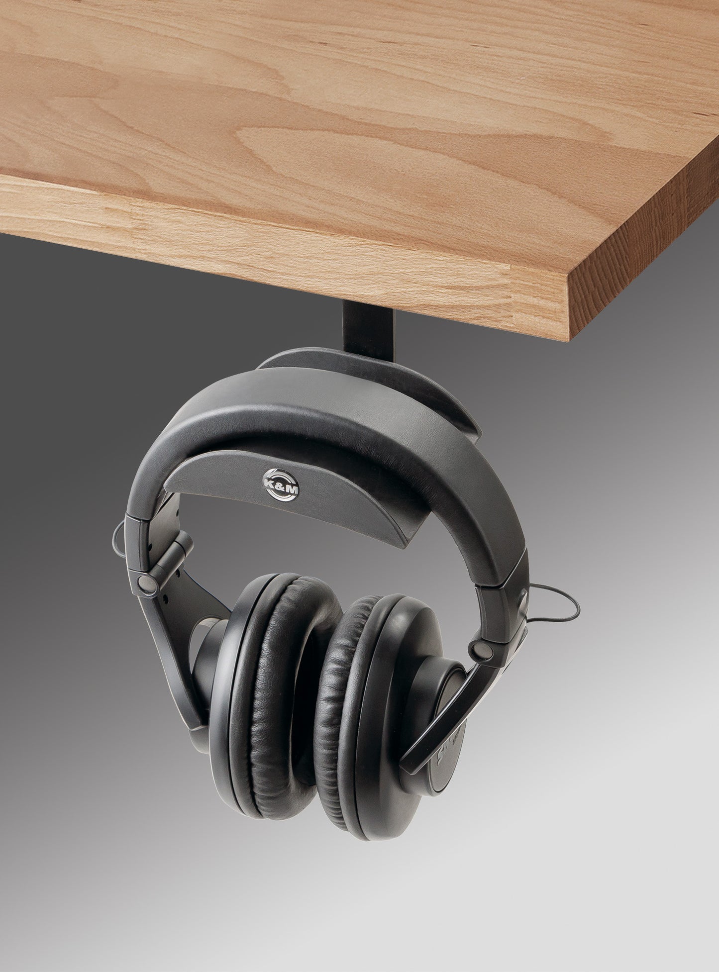 K&M audio 16330 under a wooden desk, lifestyle