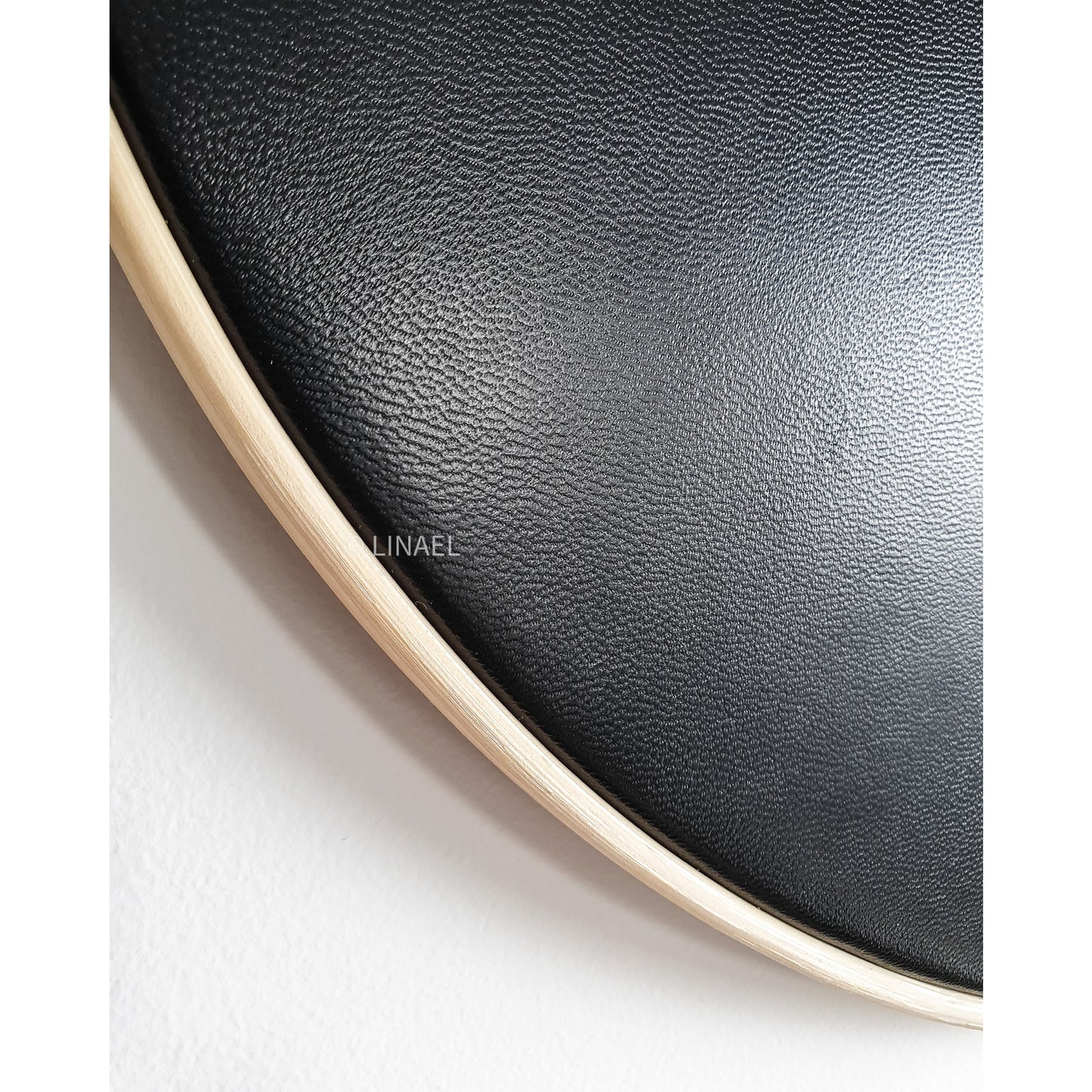 close up on black leather on lineal wall clock