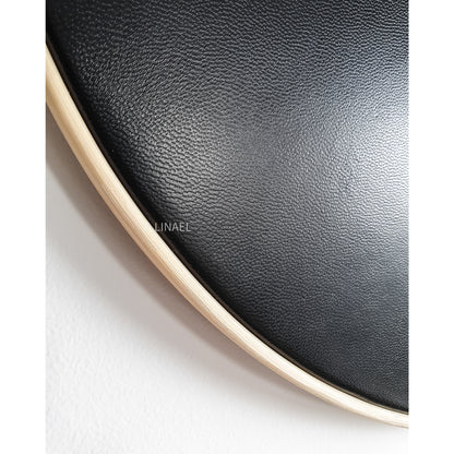 black leather wall clock, close up on white background