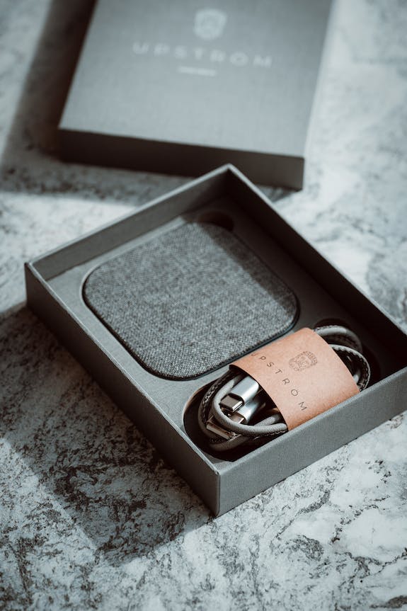 gift box with wireless phone charger inside on a table