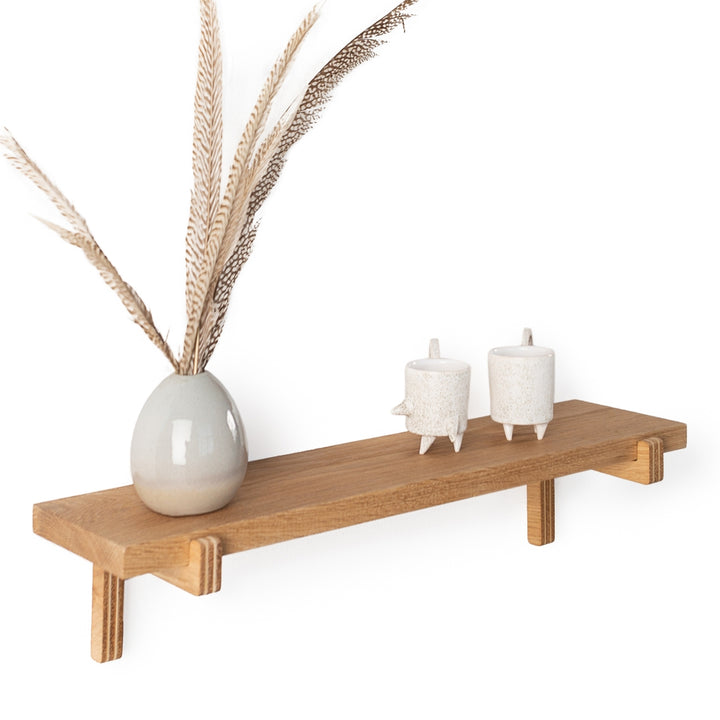 close up of an oak shelf with a planter on top
