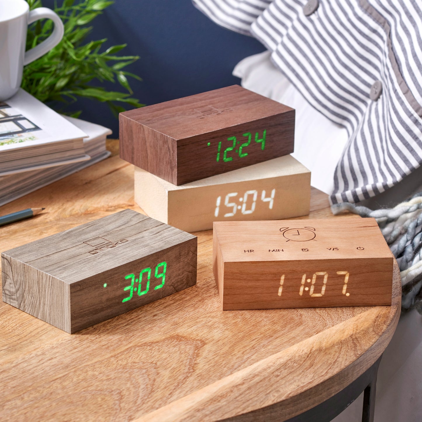 selection of four gingko flip click clocks on wooden desk