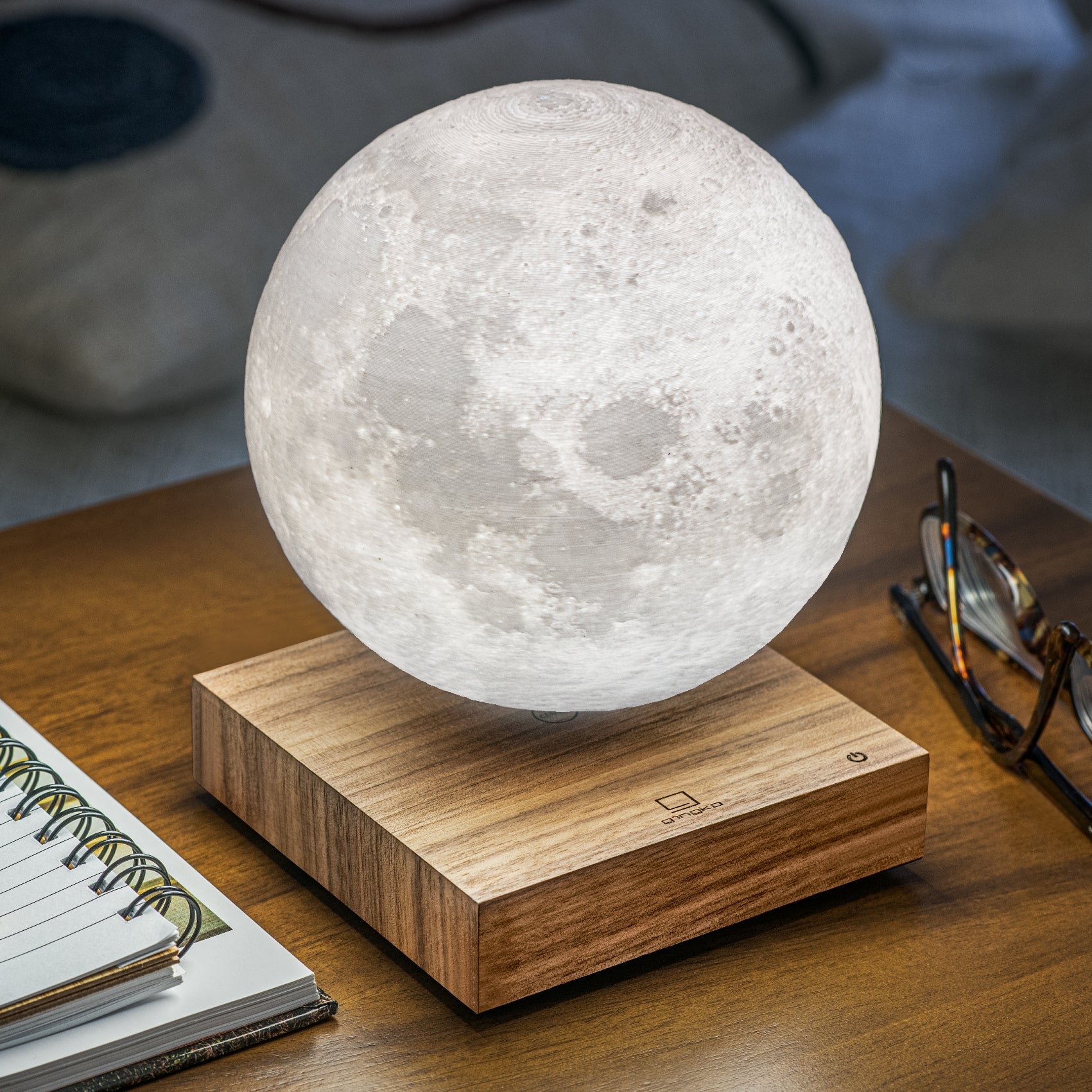 Smart Moon Lamp on desk next to a pair of glasses