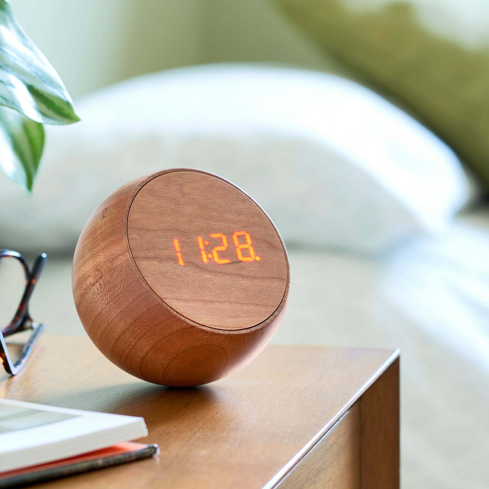 gingko tumbler click clock on wooden desk next to a plant
