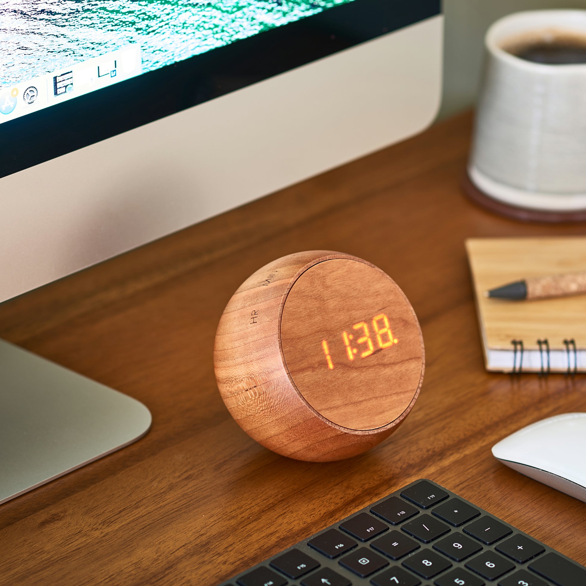 tumbler click clock on wooden desk next to iMac