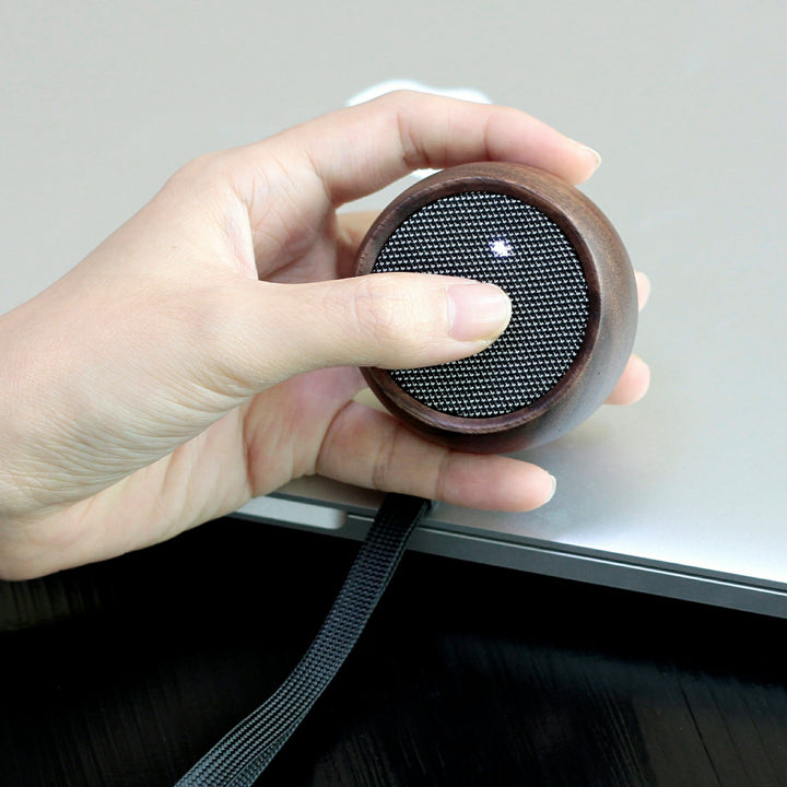 person holding gingko tumbler speaker