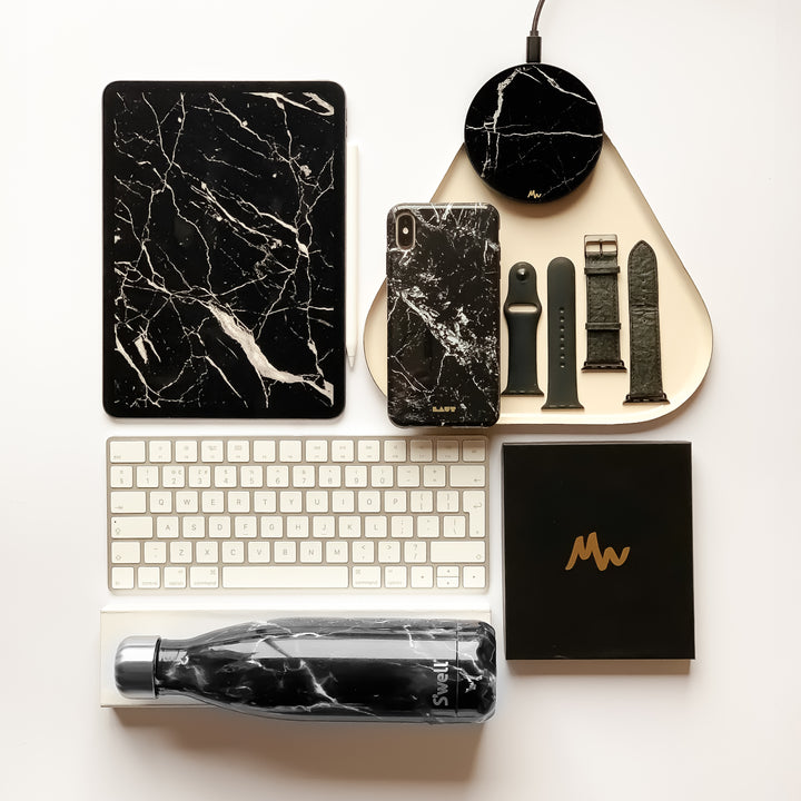 lifestyle image of wireless charger next to water bottle and apple keyboard