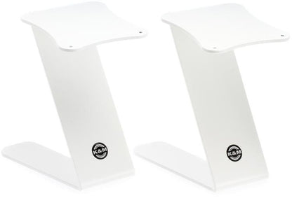 pair of white KM Audio speakers against a white background
