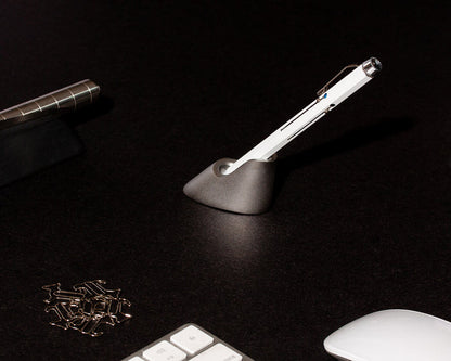 blank metal pen holder with white pen on wooden desk