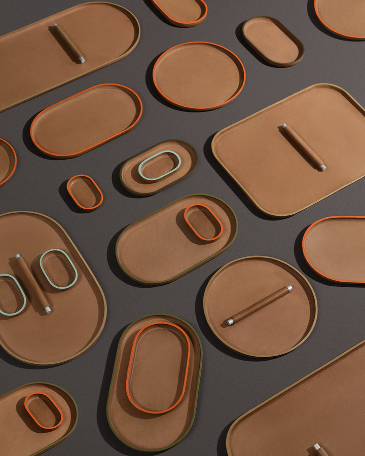 range of plato trays in real leather on a black office desk