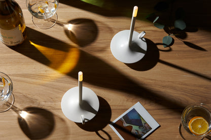 Pair of The Wick Lamps on Wooden desk next to a polaroid picture