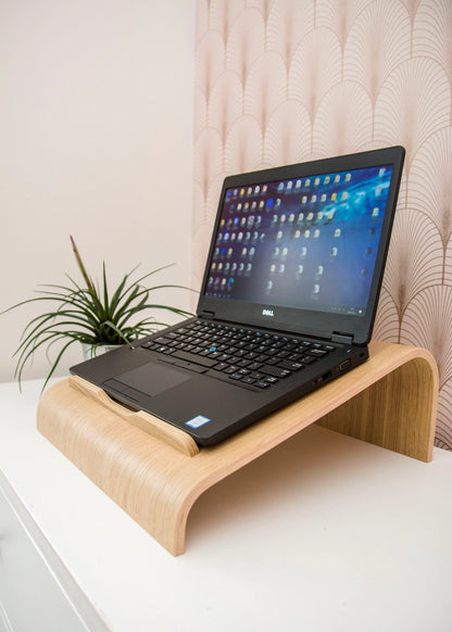 oak laptop stand with laptop on top on an office desk