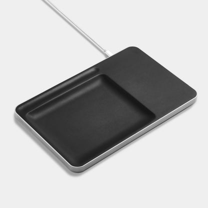 Black Leather charging station with iphone and glasses over white background