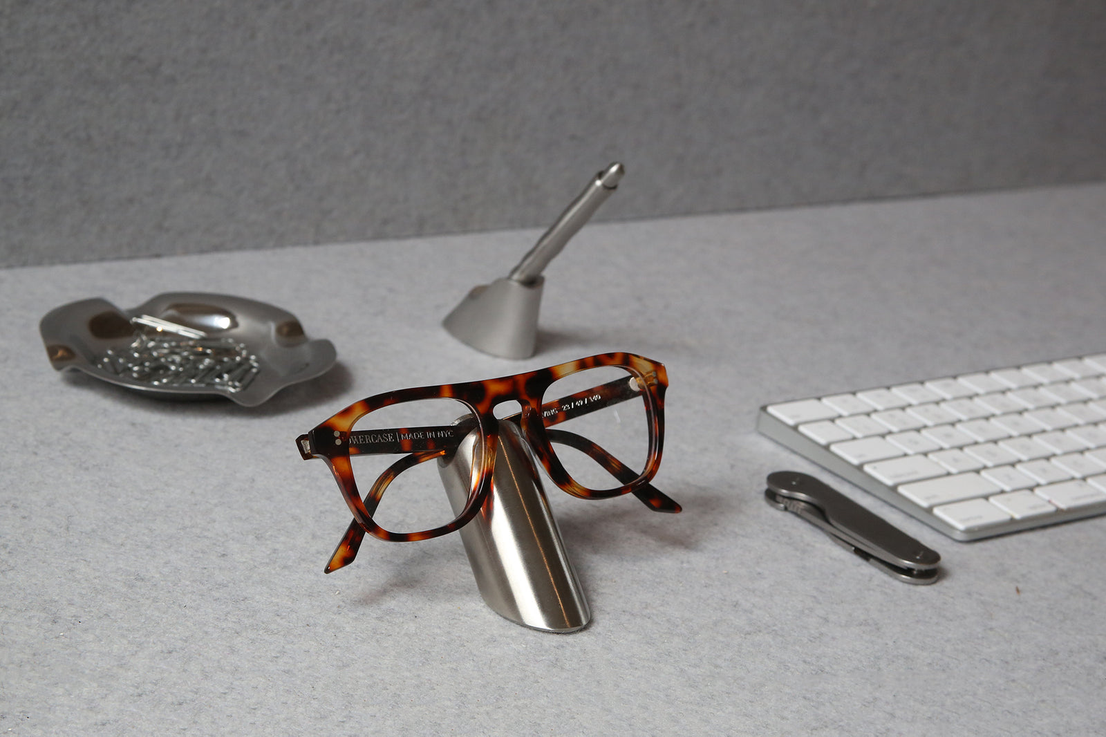 craighill eyewear stand on desk next to apple magic keyboard