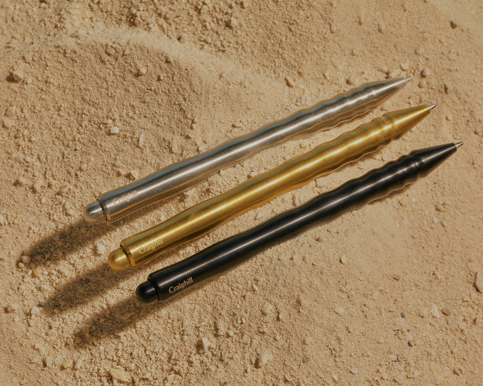 three Kepler pens on sandy background