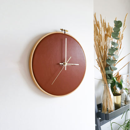 lineal wall clock in brown on white wall