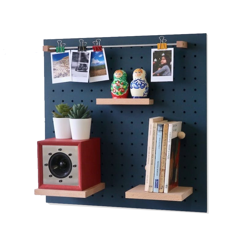 blue quark pegboard system displaying books and a clock and photos