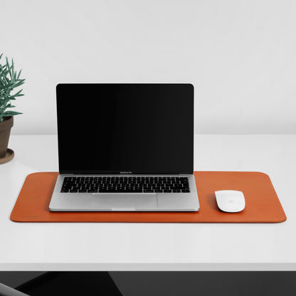 MacBook Pro and Magic Mouse on top of vachetta leather desk mat