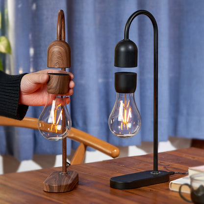 Evaro Lightbulb lamp in Walnut and Black on a desk