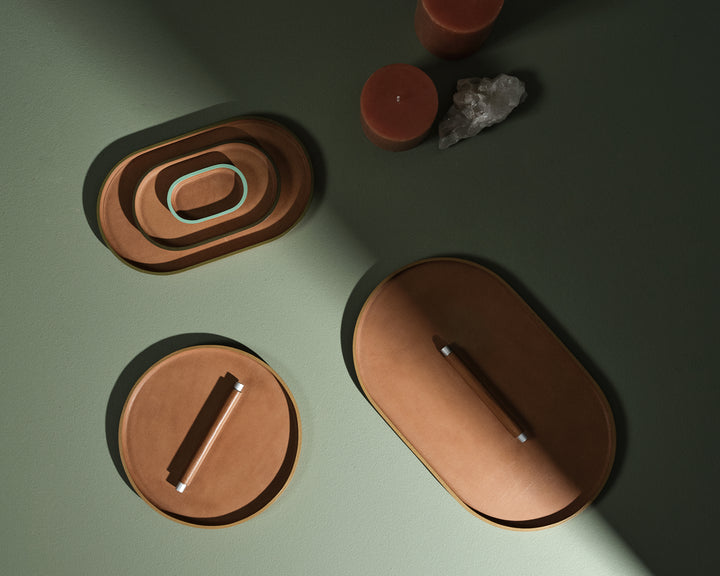 set of three stationery trays on green cloth