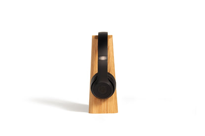 side view of Mallo headphone stand with beats headphones on top against a white background